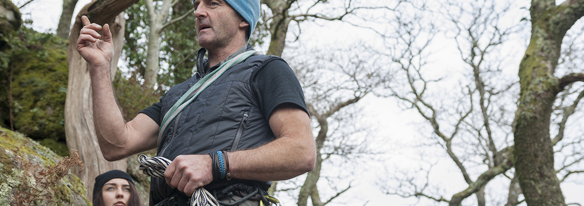 Climbers preparing for their next ascent in a lush, green setting.